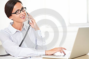 Hispanic female employee conversing on the phone
