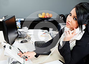 Hispanic female on phone in office