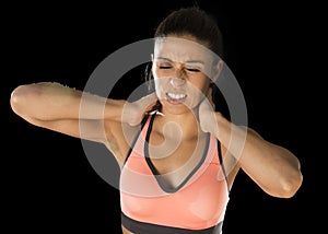 Hispanic fitness woman touching and grabbing her neck and upper back suffering cervical pain