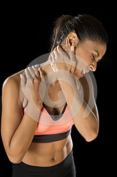 Hispanic fitness woman touching and grabbing her neck and upper back suffering cervical pain