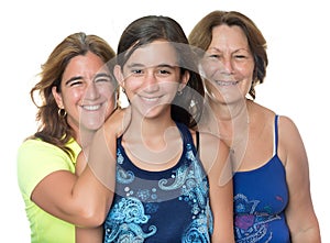 Hispanic girl with her mother and grandmother hugging and smiling