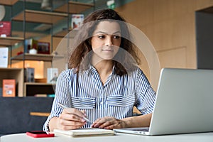 Hispanic girl student using laptop watching distance online seminar class.