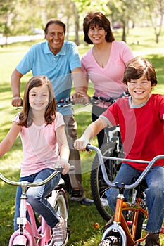 Hispanic grandparents with grandchildren on bikes