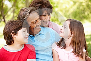 Hispanic grandparents and grandchildren outdoors