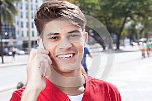 Hispanic guy in the city flirting at phone