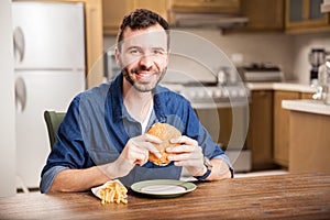 Hispanic guy eating a hamburger