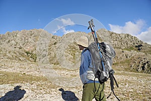 Hispanic hiker walking with his backpack, ready to start the hike