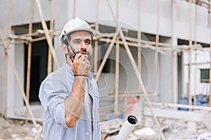 Hispanic latin indian builder work in construction site. Architect home project chief engineer with floor plan