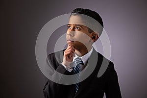 Hispanic Little Boy Deeply Meditating on Complex Subject