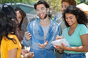 Hispanic male journalist with group of reporters at interview