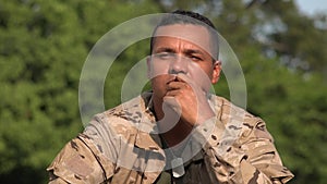 Hispanic Male Soldier Contemplating Wearing Camo