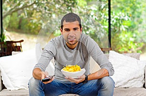 Hispanic male wearing light blue sweater plus