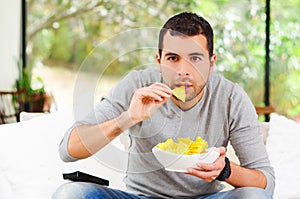 Hispanic male wearing light blue sweater plus