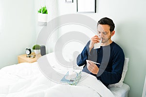 Hispanic man in bed feeling bad and sick