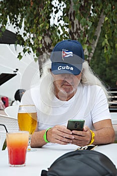 hispanic man with beer. cuban old man drinking beer. senior man drink beer from glass outdoor. Enjoy in pub. lager beer. summer