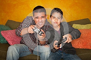 Hispanic Man and Boy Playing Video game photo