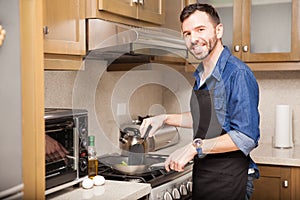 Hispanic man cooking at home