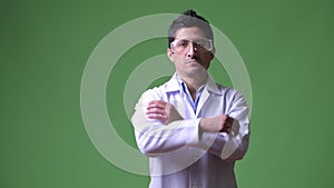 Hispanic man doctor with protective glasses crossing arms