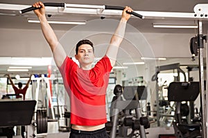 Hispanic man doing some pullups at a gym