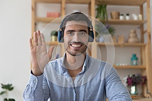 Hispanic man in headphones greet friend start video call