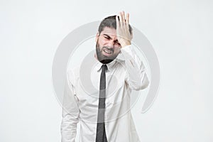 Hispanic man hold his head in hand forgotten something