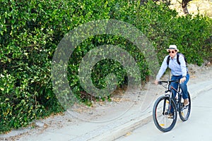 Hispanic man leaving work on a bicycle