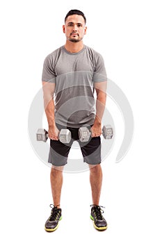 Hispanic man lifting dumbbells photo