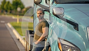 hispanic man posing in front of truck. Semi trucks vehicle. man driver near lorry truck. man driver near lorry truck