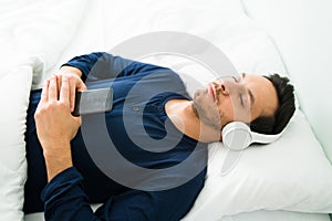 Hispanic man relaxing with a meditation in his bedroom