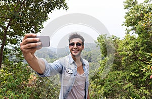 Hispanic Man Take Selfie Photo Over Mountain Landscape n Cell Smart Phone, Trekking Young Guy Tourist On Hike