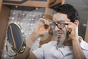 Hispanic Man Trying On Spectacles photo