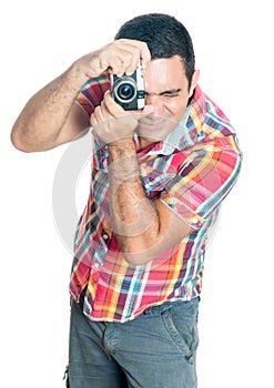 Hispanic man using a vintage looking compact camera