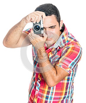 Hispanic man using a vintage looking compact camera