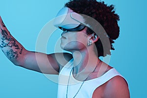 Hispanic man with VR headset against blue background