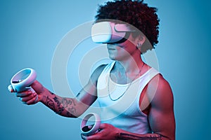 Hispanic man in VR headset near blue background