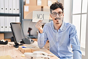 Hispanic man working at small business ecommerce holding no banner looking positive and happy standing and smiling with a