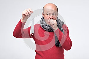 Hispanic mature man having flu and cough.