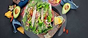 Hispanic mexican food, meat tacos with shrimps on dark background
