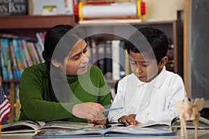 Hispanic Mom and Boy in Home-school Setting Studying Rocks