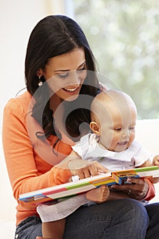 Hispanic mother and baby at home