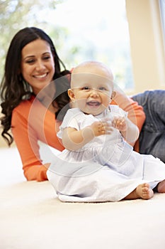 Hispanic mother and baby at home