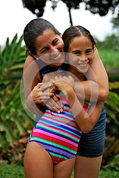 Hispanic Mother hugging her daughter
