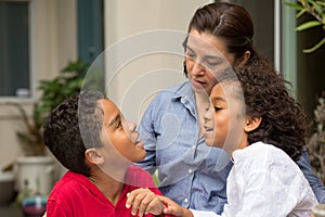 Hispanic mother talking with her childeren.