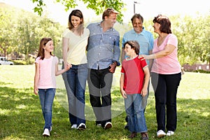 Hispanic Mulit generation family walking in park