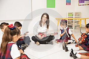 Hispanic music teacher in a preschool classroom