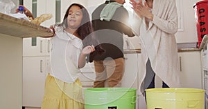 Hispanic parents and daughter teaching segregating plastic and paper trash