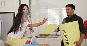 Hispanic parents and daughter teaching segregating plastic trash