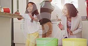 Hispanic parents and daughter teaching segregating plastic trash