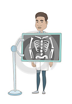 Hispanic roentgenologist during x ray procedure.