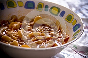 Hispanic rustic pasta bows soup.